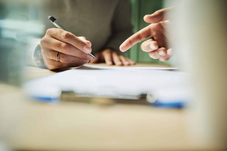Two people going through a document together – free, no-obligation initial consultation with PeRoBa®